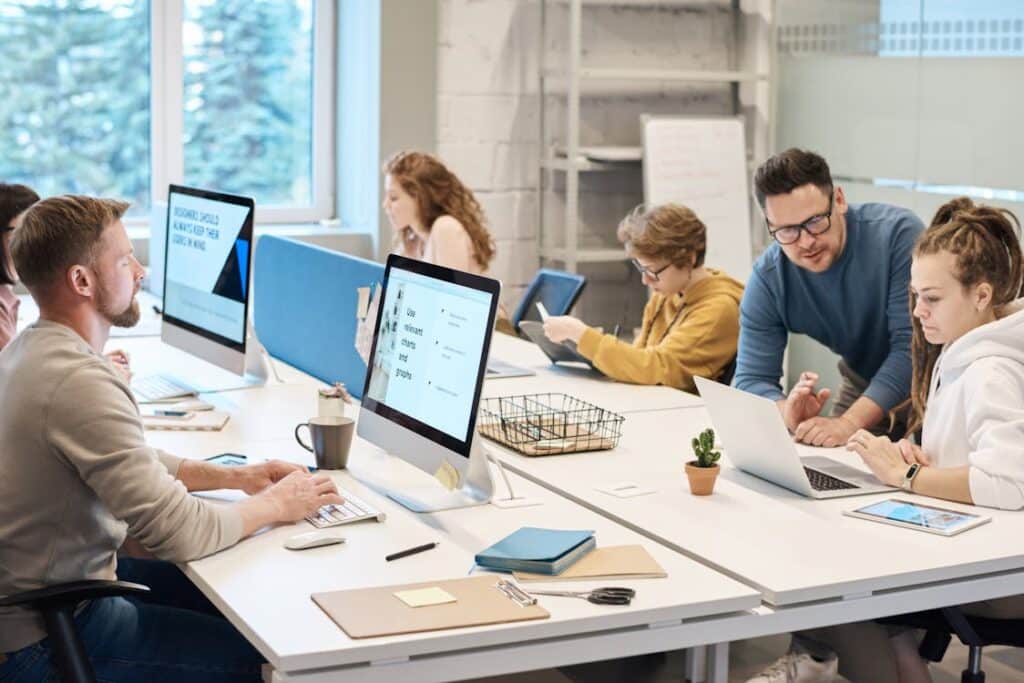 A group of people in an office working on their respective devices