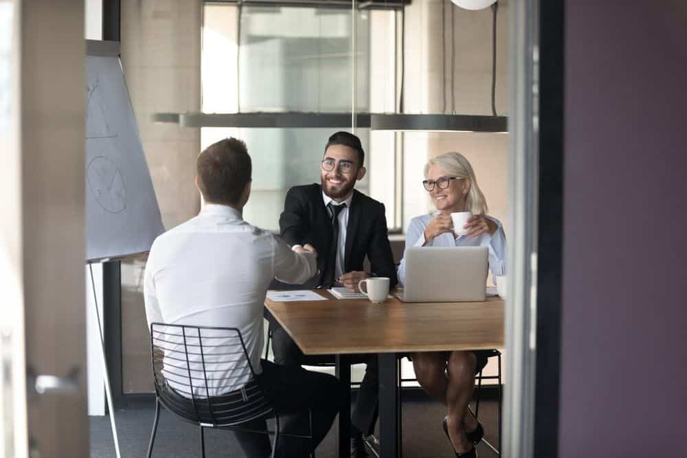 Business professionals shaking hands in a meeting room