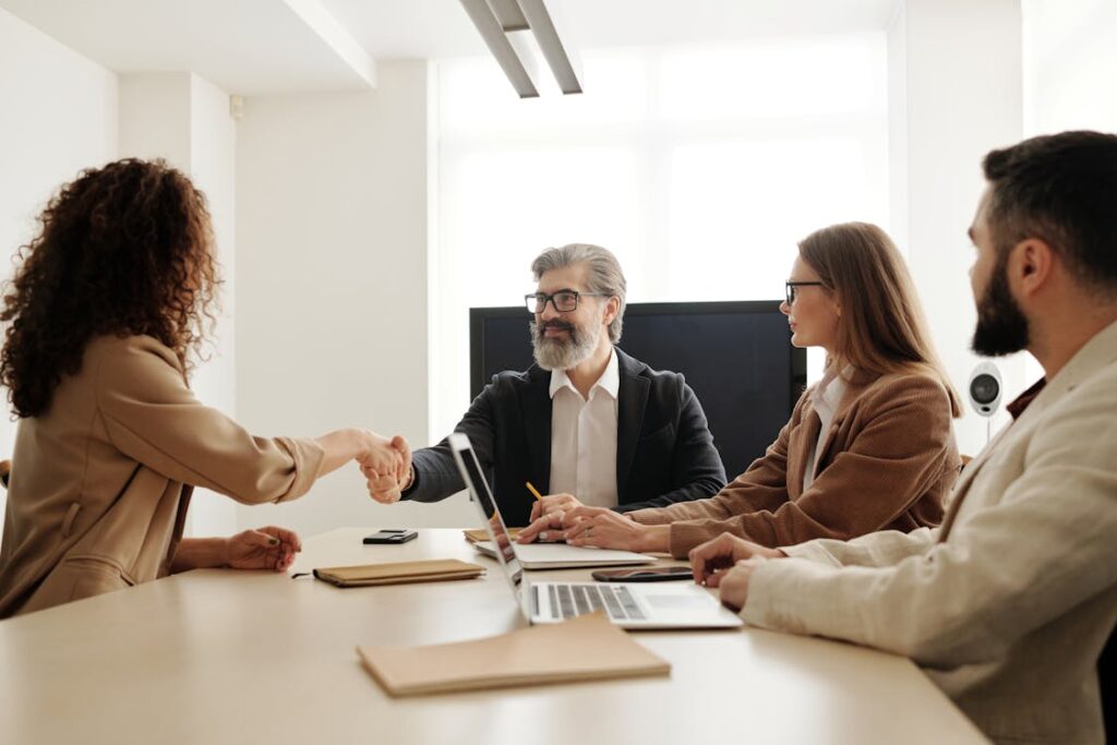 Business team welcoming a new member with a handshake