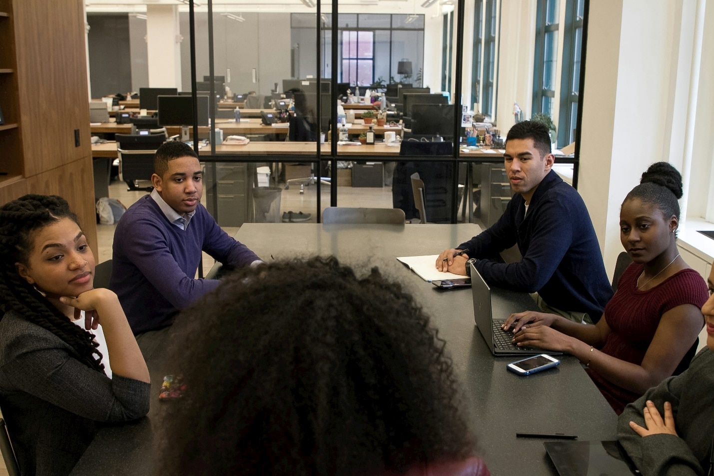 A group of professionals discussing in a conference room