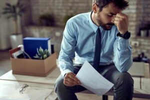Concerned man reviewing termination papers, highlighting employee-related cybersecurity risks