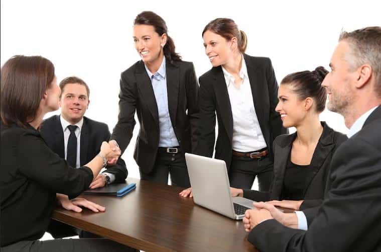 a group of people in a meeting. 